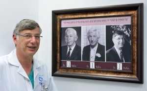 Dr. Balkin beside a picture of himself, his father, and grandfather - three generations of physicians (CC IsraCast) (Photo: Tomer Yaffe)